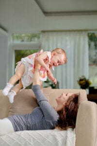 Mother joyfully playing with her daughter at home, promoting family-friendly services by Old Bay Pest Control in Annapolis, MD, US.