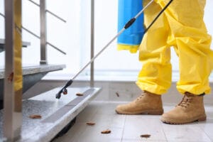 Pest control technician treating a home for cockroaches